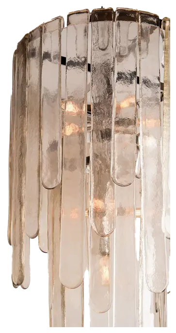 Tiered chandelier composed of translucent vertical glass pieces.