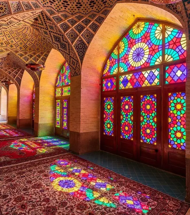 Reference photograph of an Iranian hall lit through vivid Orosi stained glass.