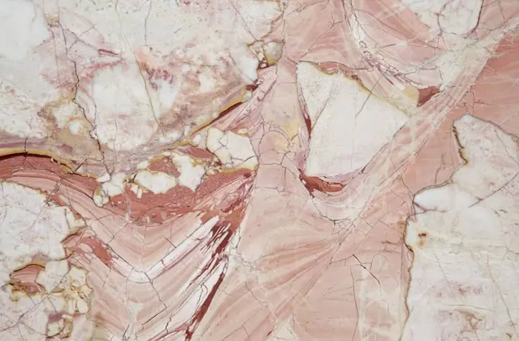 Rose, cream and ochre veined stone texture.